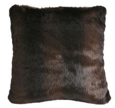 a brown and black fur pillow on a white background