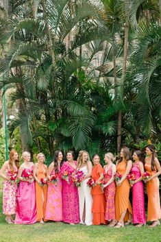 a group of women standing next to each other in dresses