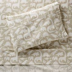 an elephant print sheet set on top of a bed