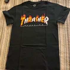 Thrasher Black T-Shirt Size Small Nwt - Never Worn Was A Birthday Gift And Didn’t Want It The Tags Came Off But Still Have Them Yellow Grunge Tops For Streetwear, Urban Tops With Logo Print For Skateboarding, Black Urban Tops For Skateboarding, Black Tops With Logo Print For Skateboarding, Black Logo Print Top For Skateboarding, Hip Hop Tops With Letter Print For Skateboarding, Black Graphic Tee For Skateboarding, Urban Black T-shirt For Skateboarding, Black Urban T-shirt For Skateboarding