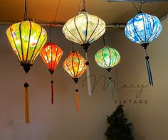 five colorful lanterns hanging from the ceiling