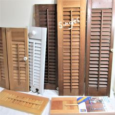 several wooden shutters are on display next to each other