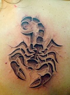 a tattoo on the back of a woman's shoulder with a scorpion in it