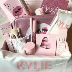 a pink gift bag filled with makeup and personal care items