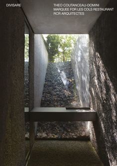 the cover of an architectural magazine with a long bench in front of a stone wall