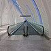 an empty airport terminal with blue lines going through the ceiling and on to the ground