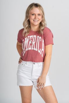 America XL cropped t-shirt from Lush Fashion Lounge women's boutique in Oklahoma City. Lush boutique in OKC has a variety of cute 4th of July t-shirts, tank tops, and more! Show your lobe for our country in this trendy 4th of July tee! Model is 5'2 size 25 wearing size small. Red Cropped Cotton T-shirt, Red Graphic Tee Cropped T-shirt, Red Cropped Cotton T-shirt With Graphic Print, Red Cotton Cropped T-shirt With Graphic Print, Red Graphic Print Crop Top For Summer, Casual Cropped Letter Print Tops, Red Cropped Cotton T-shirt With Letter Print, Red Cotton Cropped T-shirt With Letter Print, Red Cropped Crew Neck T-shirt For Summer