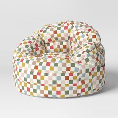 a multicolored bean bag chair sitting on top of a white floor