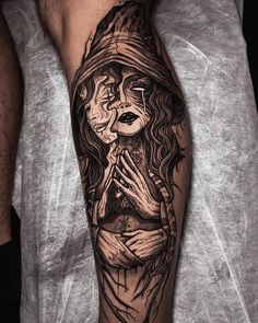 a man with a tattoo on his arm that has an image of a woman praying