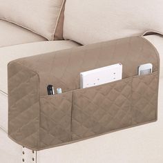 the back of a couch with an electronic device in it