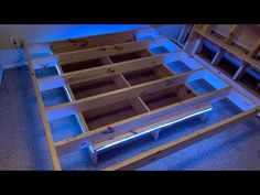 an unfinished bed frame is lit up with blue lights