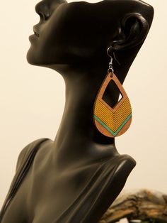 Brighten Your Style with Geometric Elegance! These handcrafted teardrop earrings feature a striking combination of brown, yellow, and teal in a bold geometric design. Lightweight and eye-catching, they're perfect for adding a pop of color to your everyday look or complementing a boho-chic outfit. ✨ Product Features: Material: Eco-friendly wood with vibrant painted accents for a natural yet modern aesthetic. Design: Teardrop shape with geometric patterns in brown, yellow, and teal, creating a bol Unique Brown Earrings For Gift, Bohemian Brown Earrings As Gift, Bohemian Brown Earrings For Gift, Artisan Brown Teardrop Earrings, Unique Brown Teardrop Earrings, Handmade Teardrop Earthy Earrings, Handmade Earthy Teardrop Earrings, Artisan Brown Earrings For Gift, Unique Brown Hoop Earrings For Gift