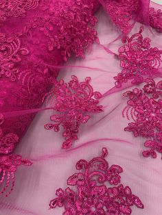 pink lace fabric with flowers on it