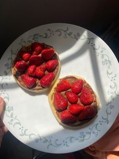 two strawberry pies sitting on top of a white plate