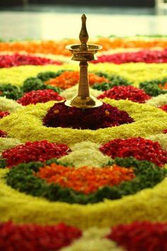 an elaborately designed carpet with a fountain in the center and flowers all around it