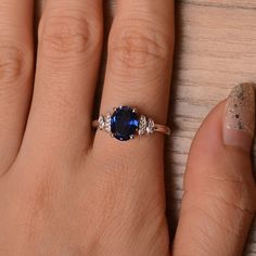 It is a lab sapphire ring. The main stone is 7 mm*9 mm oval cut.weight about 2.32 carats. The basic metal is sterling silver and plated with rhodium. To change the metal to a solid gold (white/rose) or platinum is also available, please ask for a quotation if you want. You can also go to my shop Home for more elegant rings: https://www.etsy.com/shop/godjewelry?ref=hdr_shop_menu Sapphire is September birthstone. More sapphire rings: https://www.etsy.com/shop/godjewelry?section_id=20715031 Customi Oval Birthstone Jewelry With Lab-created Sapphire, Oval Lab-created Sapphire Birthstone Jewelry, Sapphire Sterling Silver Ring For Proposal, Oval Sterling Silver Proposal Jewelry, Oval Sterling Silver Jewelry For Proposal, Oval Sapphire Birthstone Ring In Cubic Zirconia, Silver Oval Sapphire Birthstone Ring, Classic Silver Birthstone Ring With Lab-created Sapphire, Oval Sapphire Birthstone Ring