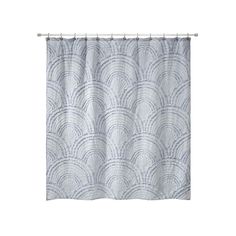 a blue and white shower curtain with an abstract design