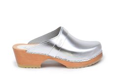 Berkeley is a classic clog with clean Scandinavian design. The clogs come in silver leather. The clogs are made on our varnished comfy bottoms which makes them great in different weather conditions. Heel height: 5 cm Platform height: 2.5 cm Fit: Medium width Leather Upper: Dutch silver metallic Wood: Varnished alderwood Footbed: Natural alderwood for excellent moist absorption For every pair ordered online we plant a tree with WeForest to make the earth cooler Hannah Anderson, Clogs For Women, High Heel Clogs, Swedish Clogs, Boho Sandals, Slow Fashion Movement, Wooden Clogs, Clog Heels, Clog Sandals