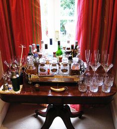 a table with many glasses and bottles on it