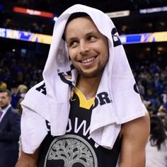 a man with a towel on his head is standing in front of a basketball court