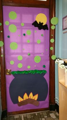 a purple door decorated with green polka dots and a pot of gold coins on it