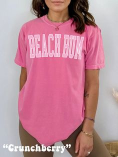 The ultimate Beach Shirt, get ready for Summer or Beachy Vacation with this cute Beach Bum Shirt! This Preppy Comfort Colors® Tshirt is super comfy! Size up for a Trendy Oversized Look! ♥ Hello and Welcome to Meaningful Tees Shop! ♥ Models are wearing Crunchberry, Chambray, Chalky Mint, Lagoon Blue, Island Reef, Washed Denim ♥ All of our items are made one at a time with care for each customer : ) ♥ Please allow 3-7 BUSINESS days (usually 3-5) for your item to be created PLUS shipping time via USPS ♥ UNISEX TEES fit like a Mens Shirt on Women, but are not overly large. ♥ For a RELAXED FIT, your usual size will typically work, but please consult the Size Chart in the Listing Photos ♥ For a TRENDY OVERSIZED FIT, size up 1, 2, or 3 Sizes! (2 sizes up is most common) ♥ For a SNUG FIT, size dow Pink Summer T-shirt For Vacation, Casual Pink Top For Vacation, Cute Pink Beach T-shirt, Cute Pink T-shirt For Beach Season, Trendy Pink Tops For The Beach, Short Sleeve T-shirt For Summer Activities, Pink Crew Neck Top For Beach Season, Pink Tops For Beach Vacation, Fun Short Sleeve T-shirt For Summer Activities