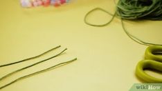 scissors and yarn on a table next to each other with needles in the foreground