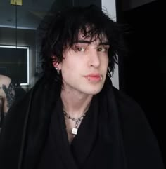 a young man with black hair and piercings