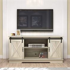 a flat screen tv mounted to the side of a wooden entertainment center in a living room