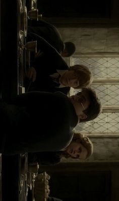 three harry potters standing in front of a clock