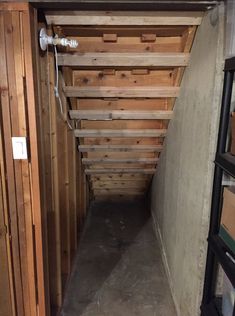 the inside of a building with wooden walls and flooring on one side, exposed pipes in the other