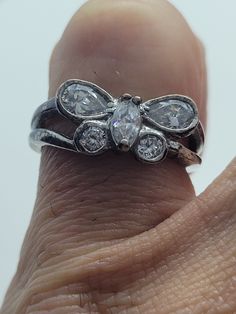 This is a vintage white sapphire ring set in 925 sterling silver, with the gemstones arranged as a mariposa butterfly. We have in size 8, this can be sized to your specification, please message us to discuss sizing your ring or engraving options. All of our jewelry is hand polished and shipped to you in a stylish gift box. We are happy to gift wrap for you. It is important to us that each customer be thrilled with their purchase. We are grateful for thousands of positive reviews. Silver Ring With Butterfly Charm For Wedding, Classic Silver Butterfly Ring For Anniversary, Vintage Sterling Silver Butterfly Ring For Anniversary, Silver Butterfly Ring With Vvs Clarity For Wedding, Silver Butterfly Ring For Anniversary, White Butterfly Ring For Anniversary, Silver Cubic Zirconia Butterfly Ring, Silver Butterfly Cubic Zirconia Rings, Mariposa Butterfly