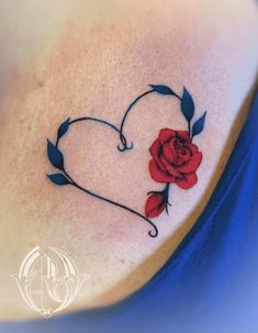 a heart shaped tattoo with a rose on it