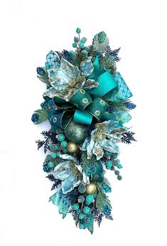 a christmas wreath with blue and green decorations