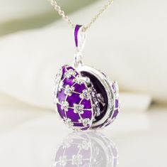 "Inspired by Faberge jewelry, egg shaped sterling silver locket enameled both outside and inside with an angel surprise, designed and made in our NJ shop. The surface of the pendant is covered with the rich purple enamel and Swarovski crystals are set in the center of the tiny 4-petal flowers. The egg is 20 mm (0.7\") long without a bail for a chain. It will come with 18\" sterling silver chain and in a gift box. We make this locket in a variety of colors, with gold plating and without, please, Oval Enamel Locket Jewelry, Enamel Locket Jewelry For Gifts, Oval Enamel Jewelry For Gift, Silver Enamel Locket Necklace, Purple Locket, Red Flower Necklace, Bouquet Jewelry, Faberge Jewelry, Faberge Egg