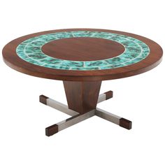 a wooden table with blue and green glass on it's top, in front of a white background