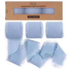 four pieces of light blue fabric in a cardboard package