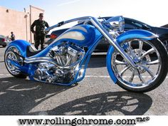 a blue and silver motorcycle parked in a parking lot