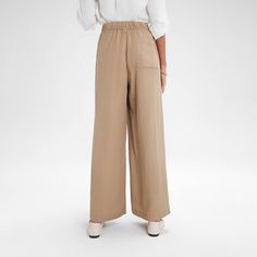 Add a touch of sophistication to your look with our wide-leg pull-on pants. The contrasting wide elastic waistband and narrow drawstring create an elegant, refined style. Made from midweight textured twill fabric, they offer a casual feel with a touch of structure, making them ideal for early autumn. Featuring a wide-leg fit and convenient side pockets, these pants are versatile enough to pair with a variety of tops for any occasion. A New Day™: Style that goes wherever you do. Business Casual Wide Leg Pull-on Bottoms, Versatile Wide Leg Pull-on Pants For Loungewear, Wide-leg Pants With Elastic Waistband For Daywear, Pull-on Style High-waisted Wide Leg Pants For Business Casual, Elegant Wide Leg Pull-on Pants For Work, Wide Leg Business Casual Pull-on Pants, Beige High-waisted Pull-on Pants, Beige Pull-on High-waisted Pants, Versatile Beige High-waisted Wide Leg Pants