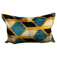 a blue, yellow and black pillow with an abstract design on the front cover is shown