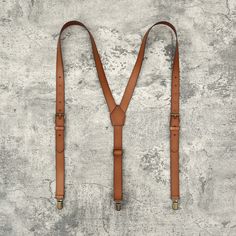 This cognac suspender with its splendid color that can match with any cognac color shoes. Our cognac genuine leather suspender is made with premium brass hardware. It is equipped three sturdy brass hardware clips that will hold your pants tightly so you don't be concern about it will loose easily. This suspender is designed for groomsman, groom, best man, father, and graduating student on the special day right here on theirs life. It will make them fell comfortable and look like much more gentle Brown Bridle Leather Belts And Suspenders For Everyday, Vintage Leather Belts And Suspenders For Casual Use, Vintage Leather Belts And Suspenders, Formal Brown Bridle Leather Belts And Suspenders, Vintage Leather Belts And Suspenders For Business, Brown Leather Belts And Suspenders With Brass Hardware, Adjustable Brown Leather Belts And Suspenders, Masculine Brown Leather Belts And Suspenders, Classic Leather Belts And Suspenders With Adjustable Fit