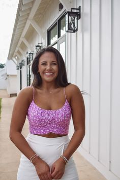 We are loving this fun and retro lavender top, featuring a smocked back with zipper closure and a wrap around tie! 100% rayon Model is 5'3" with a 34" bust, wearing a medium. Fits true to size. Trendy Lavender Tops For Day Out, Trendy Lavender Top For Day Out, Trendy Purple Tops For Brunch, Chic Purple Crop Top For Spring, Fitted Lavender Top For Vacation, Trendy Lavender Tops For Beach, Floral Print Lavender Top For Vacation, Pink Smocked Bodice Crop Top For Summer, Chic Purple Crop Top For Day Out