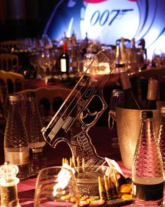 a table topped with lots of bottles and glasses