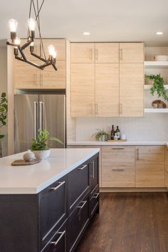 a kitchen with wooden cabinets and white counter tops, an island in front of the sink