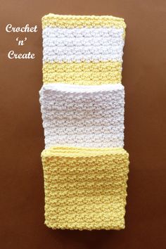 three crocheted dishcloths stacked on top of each other in yellow and white