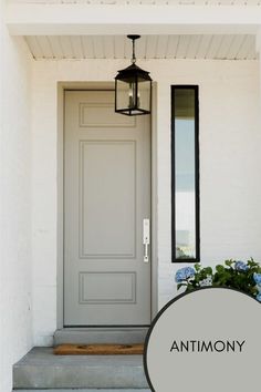 a gray front door with the words anthony on it and an image of a plant