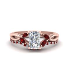 an oval cut engagement ring with red stones on the sides and a twisted band around it