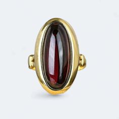 Introducing our exquisite Victorian Garnet Ring crafted in 9k yellow  gold weighing 5.8 grams. Adorned with a natural 4.5 ctw Garnet, this beautifully decorated ring is a perfect choice for an anniversary, engagement, or wedding. The radiant yellow finish adds a touch of warmth and sophistication, making it a timeless piece for her collection. Elevate your style with this unique and meticulously crafted ring, a celebration of love and elegance. Gold Oval Cabochon Sapphire Ring For Formal Occasions, Formal Gold Oval Cabochon Sapphire Ring, Gold Sapphire Ring With Oval Cabochon For Formal Events, Formal Gold Sapphire Ring With Oval Cabochon, Formal Yellow Gold Ruby Ring With Cabochon, Victorian Yellow Gold Rings With Polished Finish, Victorian Gold Domed Rings, Antique Gold Domed Ring, Elegant Gold Garnet Cabochon Jewelry