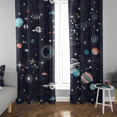 the curtains in this room are decorated with planets and stars