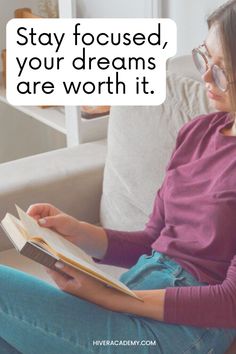 a woman sitting on a couch reading a book with the caption stay focused, your dreams are worth it